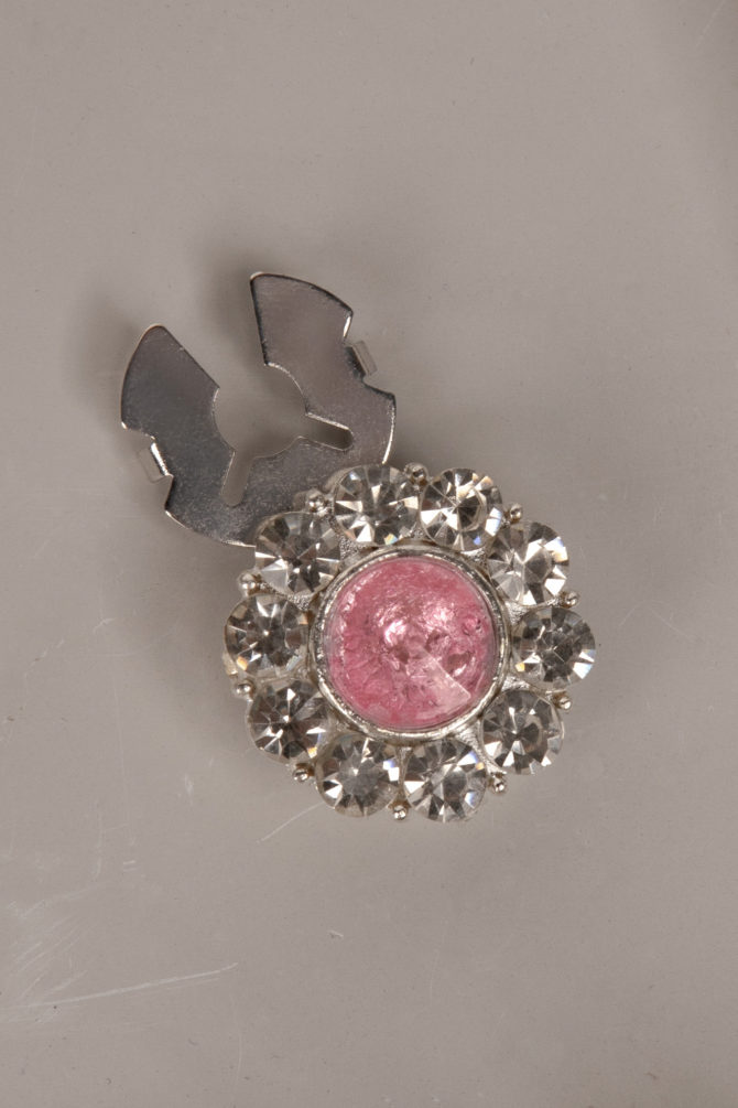 flower shaped button cover with rhinestones and a pink center by Avrel.